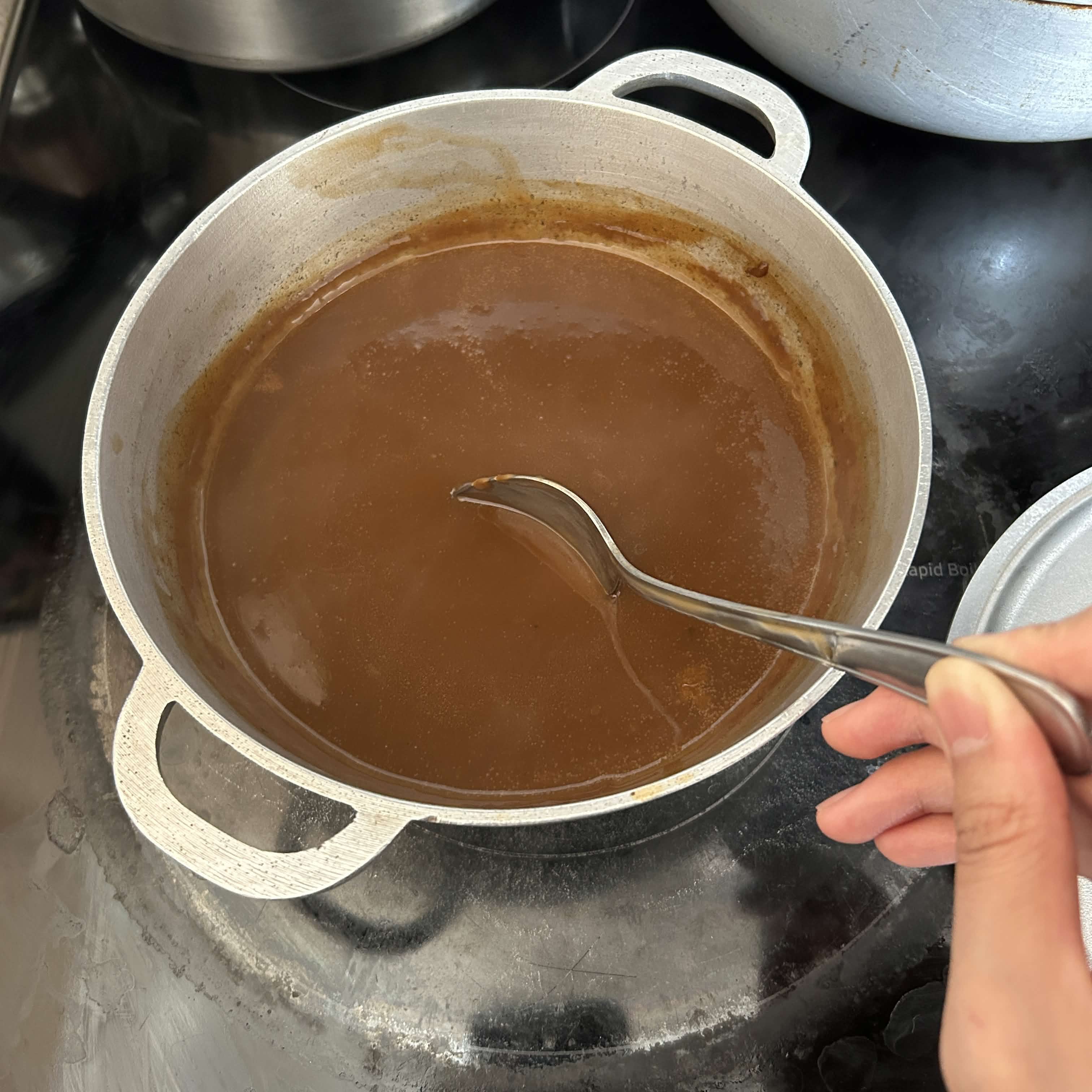 Stirring gravy in a pot